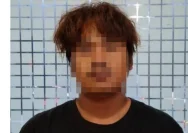 Pelaku begal taksi online berinisial AF saat diamankan pihak kepolisian